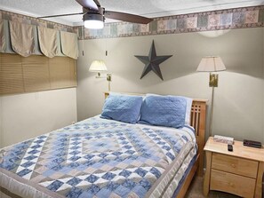 Queen-sized bed in bedroom; with Flat screen TV