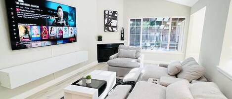 TV room with new 85 inch Samsung QLED TV and high end premium fabric couches.