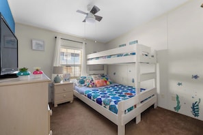 Our bunkroom features underwater decor with a Roku enabled TV, ceiling fan, closet and Twin XL over Queen size bunkbed.