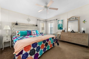 The primary bedroom features a king size bed, dresser, walk in closet, and TV with Roku. The primary bath is also attached.