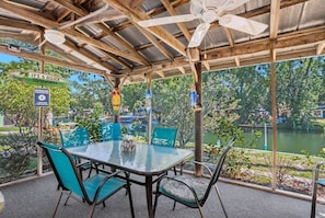 Our screened lanai offers plenty of space to relax, including an outdoor dining set, grill, fans, and porch swing.