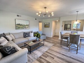 Living room and dining area, kitchen, and pantry with stacked washer and dryer.