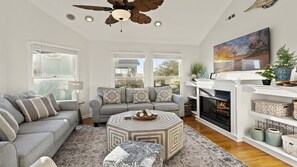 Relax in the spacious Living Area where you can bask in the brilliant natural light of multiple floor-to-ceiling windows and gather around  for cozy family movie nights in front of the Flat Screen TV. (Please Note: The fireplace is not for guest use.)