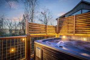 Relax to the sounds of nature as you enjoy your hot tub by the deck.