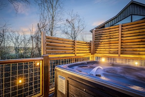 Relax to the sounds of nature as you enjoy your hot tub by the deck.