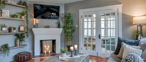 The cozy living room with widescreen TV and beautiful decor is a favorite place to relax together.