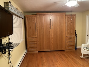 Murphy bed with hanging space and drawers on either side