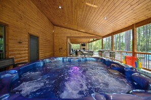 The large Hot Tub on the covered back deck is easy to enjoy and still see the surrounding nature
