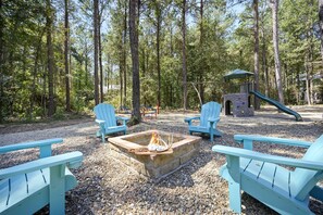 The kids will love the outdoor playset and wood burning fire pit right off the back deck