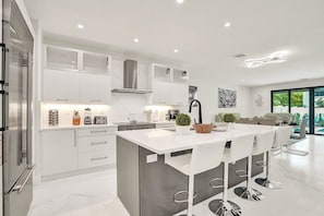 The modern, gourmet kitchen comes fully equipped with everything you could need.