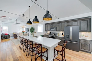 Vaulted ceiling spans the second-level living area for a wide-open feel with your group.