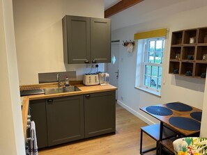 Kitchen area also has small dining table 