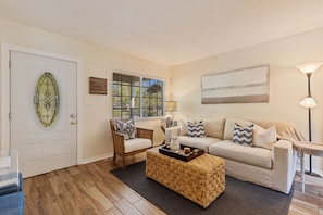 Family room with slip cover sofa and chair.