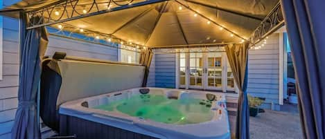 Hot tub with lit-up gazebo