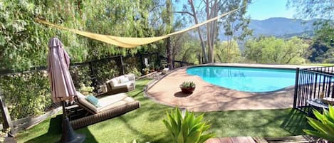 Salt water pool in manicured garden with sweeping mountain views