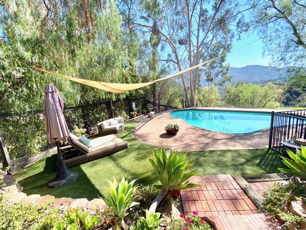 Salt water pool in manicured garden with sweeping mountain views