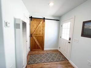 Barn door closes the bedroom, bathroom & laundry area from the main living space