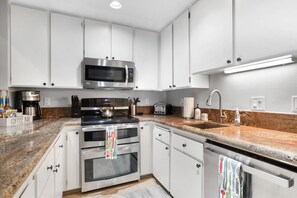 Culinary Dream: A well-appointed kitchen with sleek stainless steel fixtures and a dedicated wine fridge.