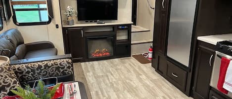 Family Room and kitchen with TV and electric fireplace