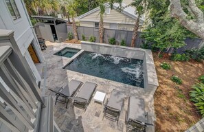 A view from the upper deck of the backyard oasis with a private pool and hot tub.