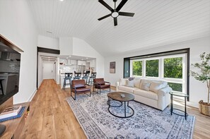 The great room has ship-lapped vaulted ceilings.