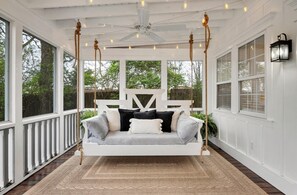Twin bed swing indoor porch with twinkle lights