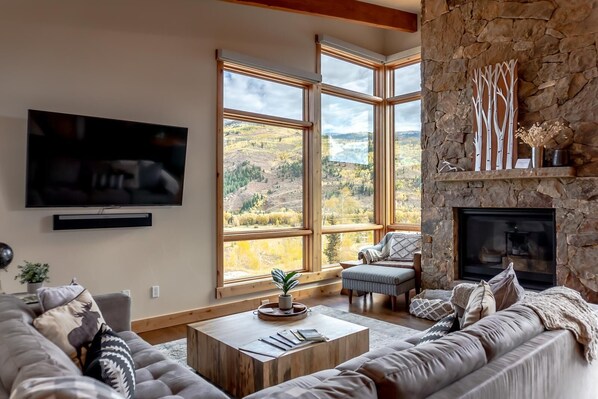 Main level living room with smart TV and gas fireplace.