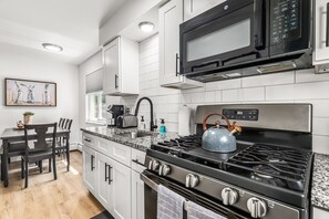 Newly renovated kitchen is stocked with all the necessary cookware to make meals at home.