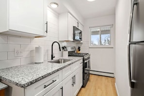 Fully Equipped Kitchen with Granite Countertop and Brand-New Slate Appliances