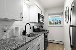 Fully Equipped Kitchen with Granite Countertop and Brand-New Slate Appliances
