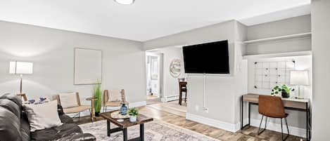 Open living space includes 55in ROKU Smart TV and Workspace