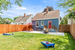 Spacious backyard features picnic table, firepit area, and outdoor games