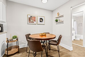 Gather around the table and enjoy a delicious meal with your loved ones in this spacious dining room. The perfect place to catch up and make memories.
