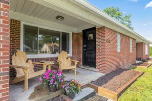 Welcome to your charming brick home away from home! This cozy porch is the perfect place to relax and enjoy the outdoors. Imagine sipping your morning coffee on the porch swing, or spending a summer evening grilling out with friends.