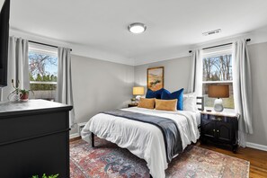 Bright & spacious bedroom offers both natural light and black out curtains