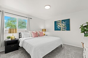 Fall asleep in style in this cozy bedroom with a plush bed and a view of the city.