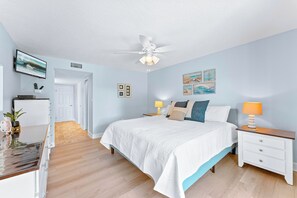 Cozy master bedroom with a king-size bed and charming beach-inspired decor.