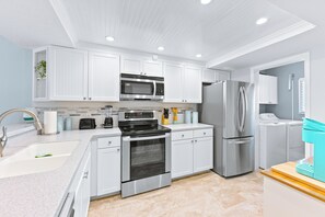 Fully equipped modern kitchen with sleek stainless steel appliances.