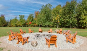 Huge fire pit with Adirondack chairs!