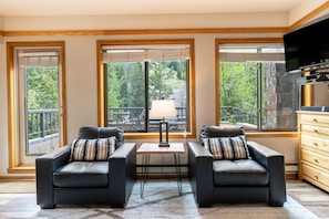 Living area featuring flat screen TV and cozy furnishings.