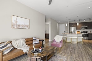 Living room with futon; note that your living room layout and decor might be slightly different since we have multiple units in this building with slightly different layouts!