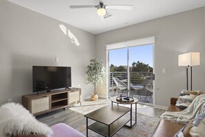 Living room with futon; note that your living room layout and decor might be slightly different since we have multiple units in this building with slightly different layouts!