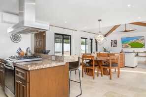 Open floor plan with glass doors that open to ocean views.