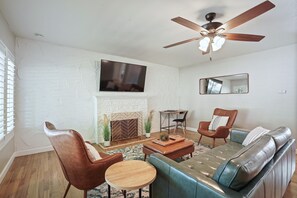 The living room is bright & spacious with plenty of comfortable seating.