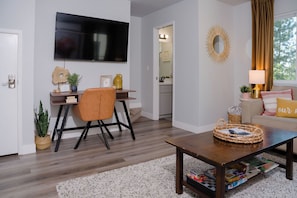 Living room with desk and TV, half bath