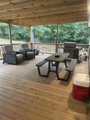 Front patio off the front door with the grill and seating. 