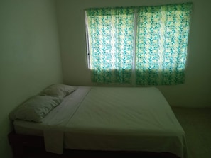 Bedroom with oscillating free-standing fan