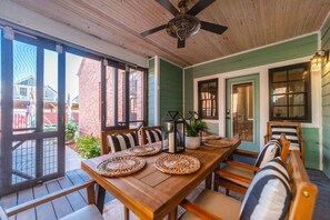 The back patio offers a seasonal dining table that is perfect for an intimate dinner at home