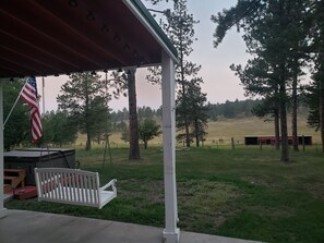 Porch swing and view of meadow