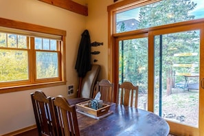 The dining table with seating for four and lots of natural light from the surrounding windows.